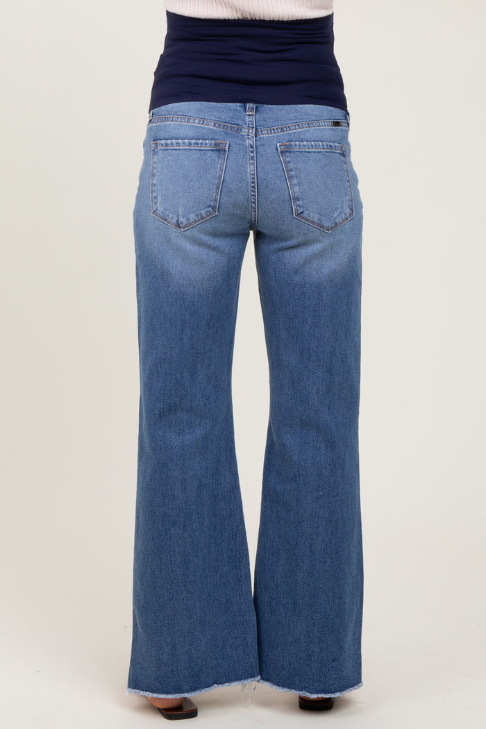 woman wearing a pair of blue maternity wide-leg jeans, viewed from the back