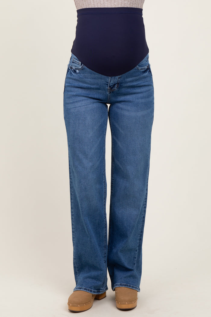 woman wearing blue maternity jeans with a navy waistband and wide leg style, no baby bump visible