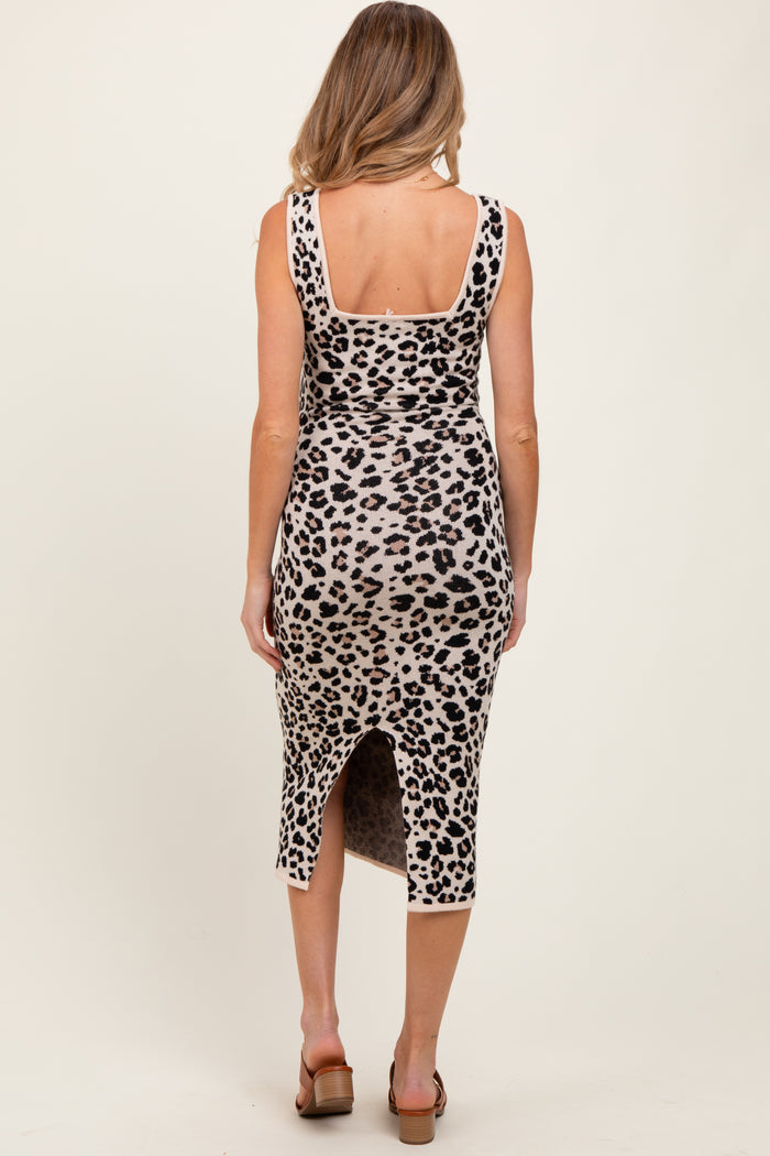 woman wearing a leopard print maternity dress with a back slit and fitted silhouette