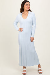 woman wearing a light blue ribbed long sleeve dress with a collared neckline and flared hem