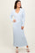 woman wearing a light blue ribbed long sleeve dress with a collared neckline and flared hem