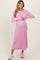 woman wearing a pink ribbed maternity dress and holding her baby bump