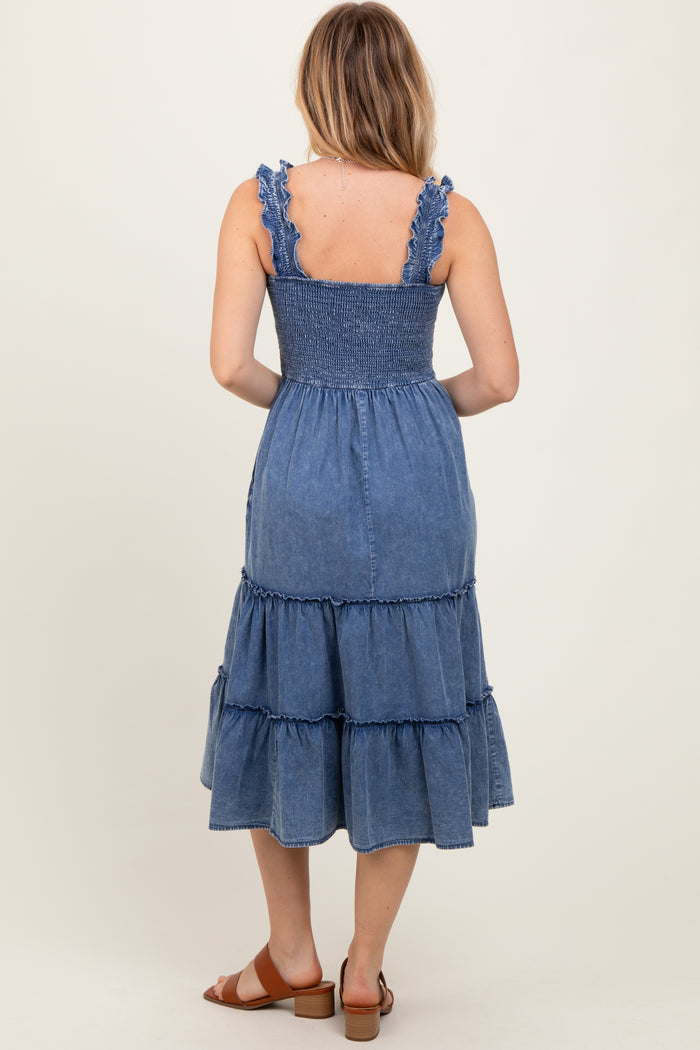 woman wearing a blue tiered denim midi dress with ruffled straps, seen from the back