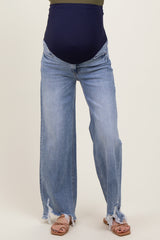 woman wearing light blue distressed maternity jeans with a dark blue over-the-bump band
