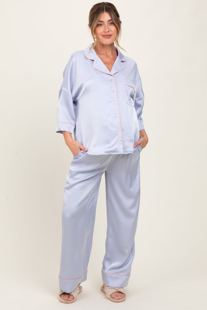 woman wearing a light purple maternity pajama set with a button-up top and wide-leg pants, showing her baby bump