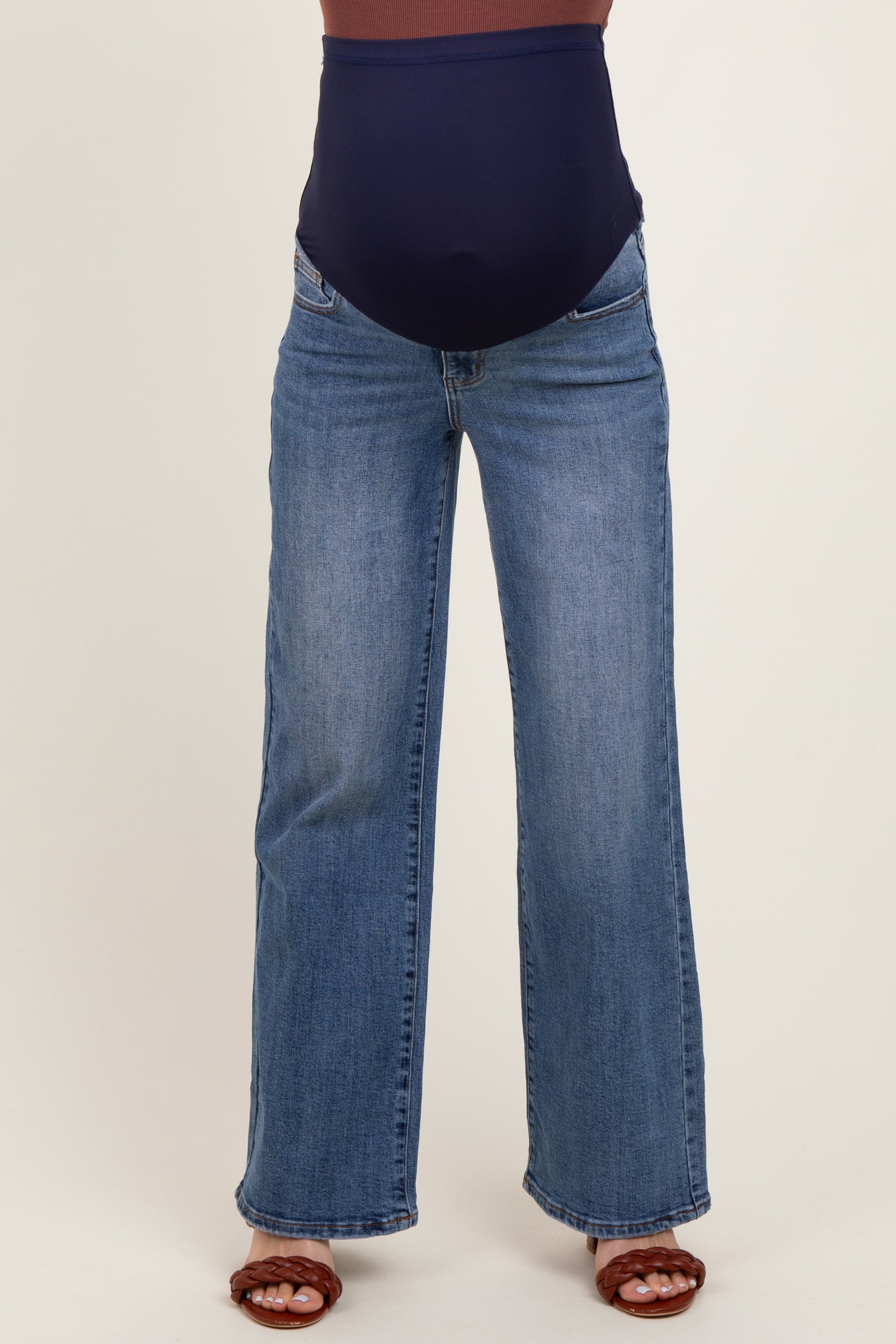 woman wearing a pair of navy blue maternity wide-leg jeans with a supportive belly panel