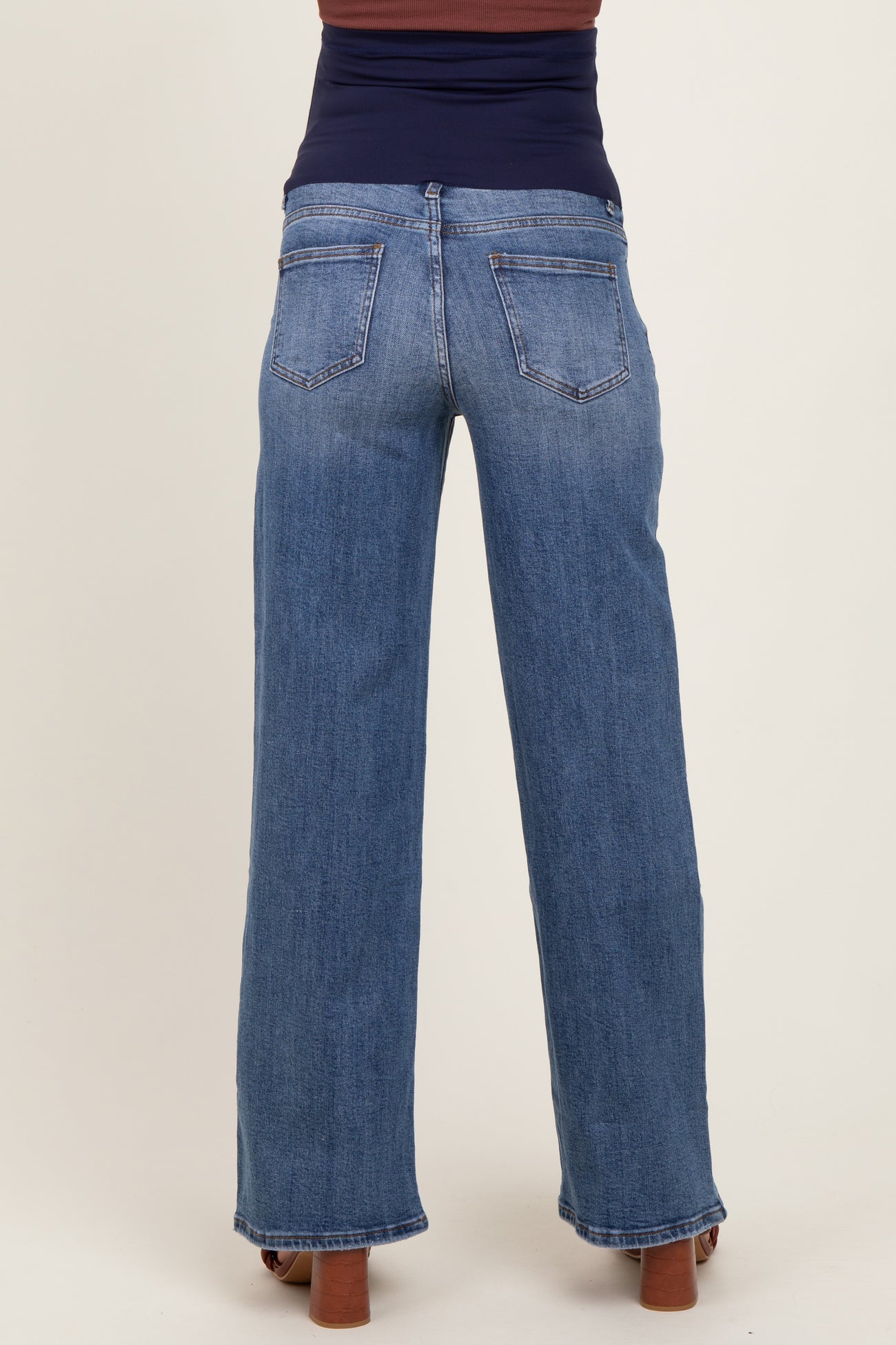 woman wearing maternity wide-leg jeans in medium wash, showing the back view