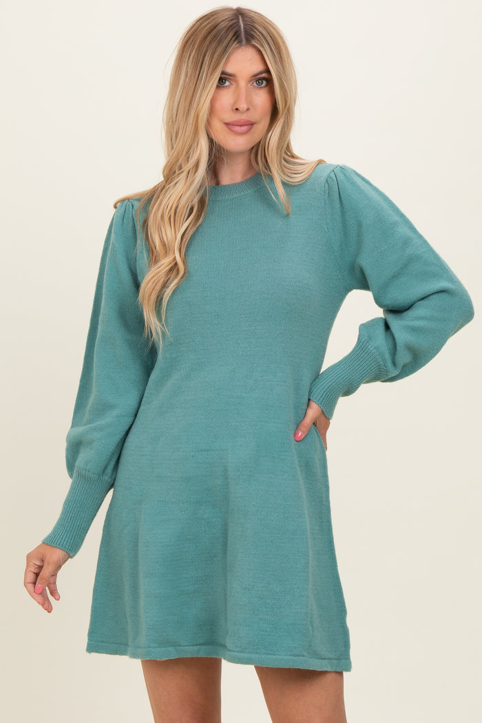 woman wearing a teal long sleeve sweater dress with puffed sleeves and a relaxed fit