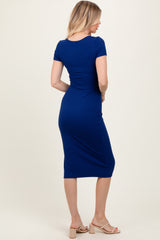 woman wearing a royal blue short sleeve fitted midi dress, viewed from the back
