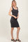 woman wearing a fitted gray ribbed tank dress with a scoop neckline and straight hem