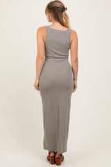 woman wearing a gray and white striped sleeveless maxi dress, viewed from the back