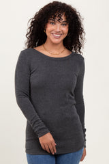 woman wearing a dark gray ribbed long sleeve top with a round neckline and a fitted silhouette
