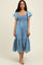 woman wearing a light blue smocked maxi dress with flutter sleeves and a tiered skirt