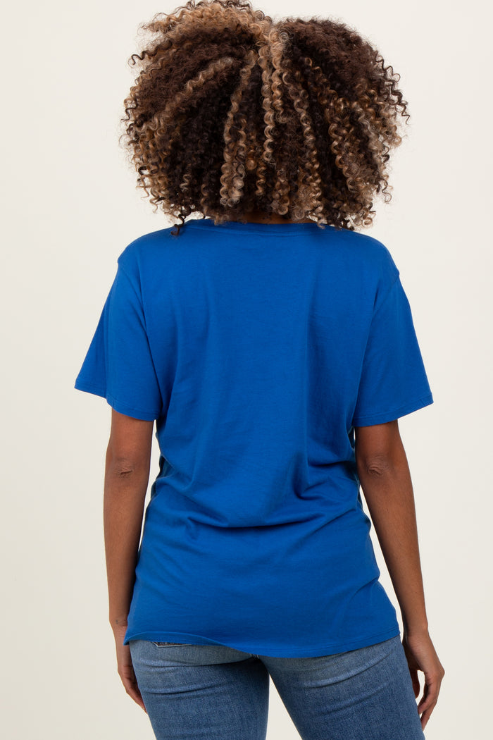 woman wearing a blue short sleeve maternity t-shirt, visible baby bump under the fabric, shown from the back