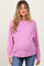 woman wearing a light pink maternity sweatshirt with a relaxed fit and a visible baby bump