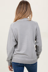 woman wearing a gray maternity sweatshirt with ribbed cuffs and hem, viewed from the back