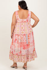 woman wearing a floral print plus-size maxi dress with a ruffled hem and a scoop back