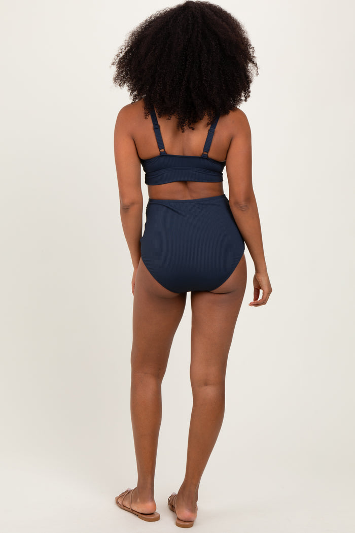 woman wearing a navy ribbed high-waisted bikini from the back with a supportive top and minimal tan lines
