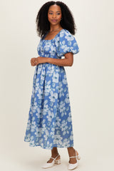woman wearing a blue floral maxi dress with puff sleeves and a square neckline