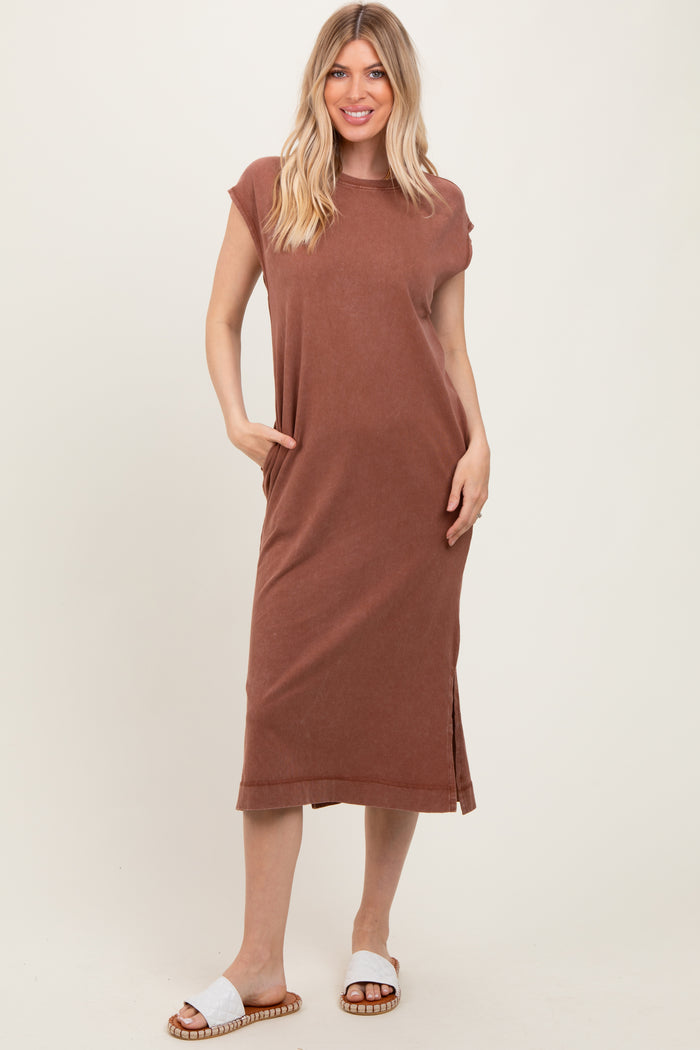 woman wearing a rust-colored sleeveless maxi dress with side pockets and a relaxed fit