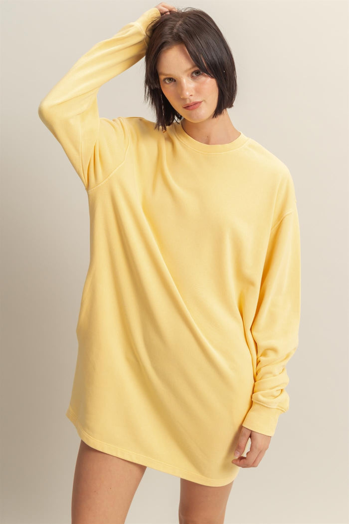 woman wearing a yellow oversized long sleeve sweatshirt dress