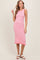 woman wearing a pink and white striped sleeveless midi dress with a ruffled hem and sandals