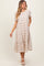 woman wearing a beige plaid tiered midi dress with short sleeves and pockets