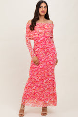 woman wearing a pink floral off-shoulder maxi dress with long sleeves and a fitted silhouette