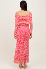 woman wearing a pink off-the-shoulder floral maxi dress with a fitted silhouette and sheer overlay