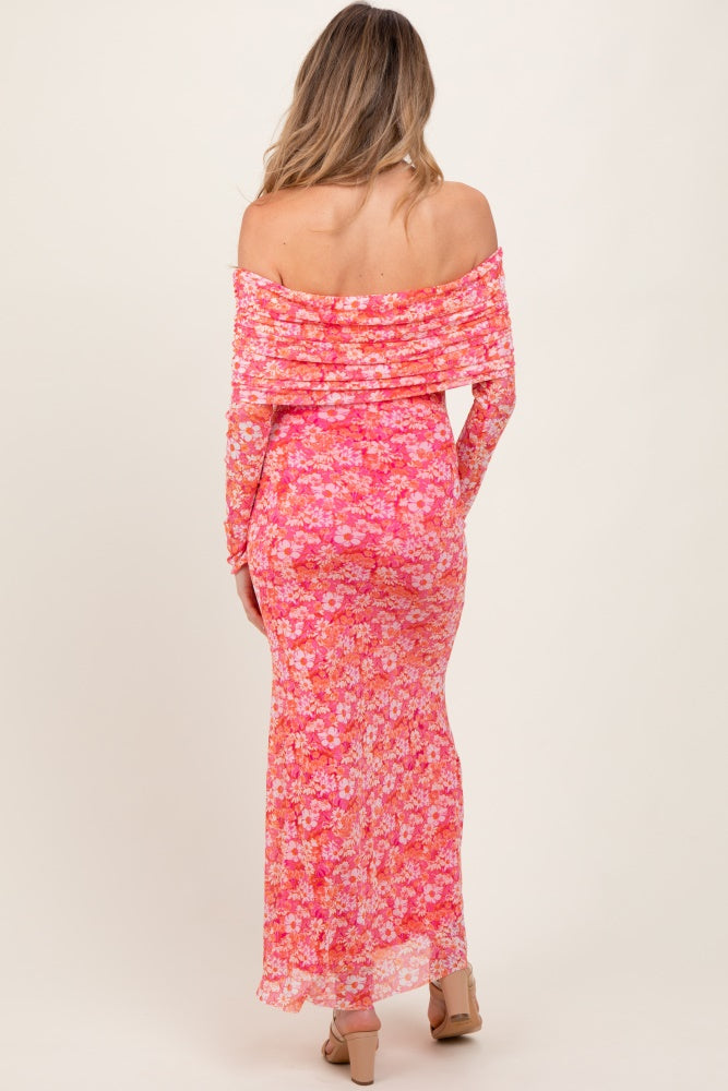 woman wearing a pink floral off-shoulder maternity dress, showcasing a fitted style and long sleeves from the back