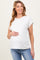 woman wearing a light beige short sleeve maternity top and holding her baby bump with a smile