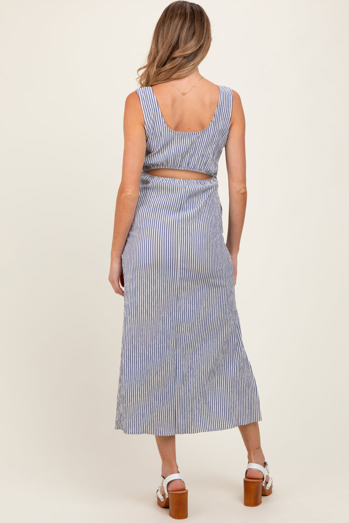 woman wearing a blue and white striped backless maternity dress with a fitted bodice and flowy skirt