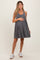 woman wearing a gray ribbed maternity dress and holding her baby bump