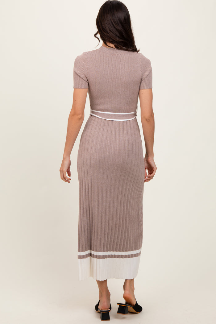 woman wearing a ribbed midi dress in taupe with a fitted design and white stripe detail at the hem