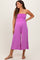 woman wearing a pink strapless maternity jumpsuit with a gathered bodice and wide-leg pant style