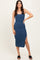 woman wearing a dark blue ribbed midi dress with a side slit and spaghetti straps