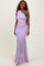 woman wearing a lavender one-shoulder evening gown with ruched details and a flowing mermaid skirt