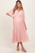 woman wearing a light pink pleated maternity dress with a v-neckline and a visible baby bump
