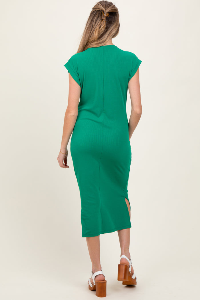 woman wearing a green cap sleeve maternity dress with a side slit, showing her baby bump from the back