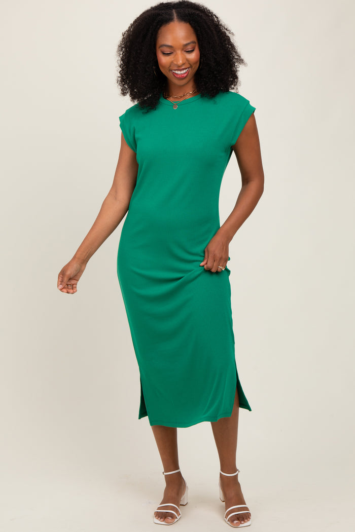 woman wearing a green sleeveless midi dress with side slits and a relaxed fit