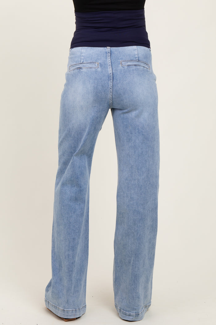 woman wearing light blue maternity flared jeans, seen from the back