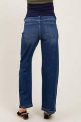 woman wearing a pair of blue maternity jeans with a soft stretch waistband, standing with her back to the camera