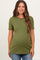 woman wearing a dark green ribbed maternity top with scalloped edges and a visible baby bump