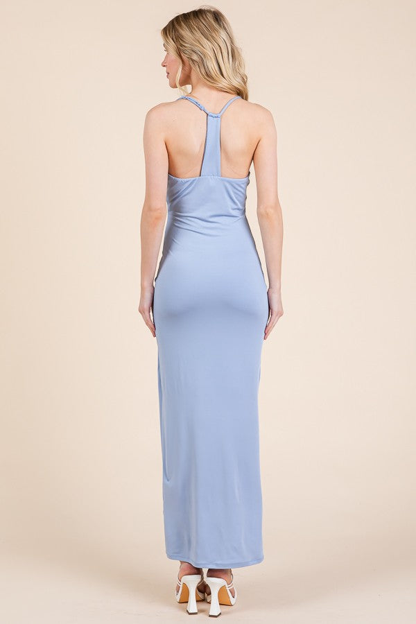 woman wearing a light blue satin maxi dress with adjustable straps and a fitted silhouette, view from the back