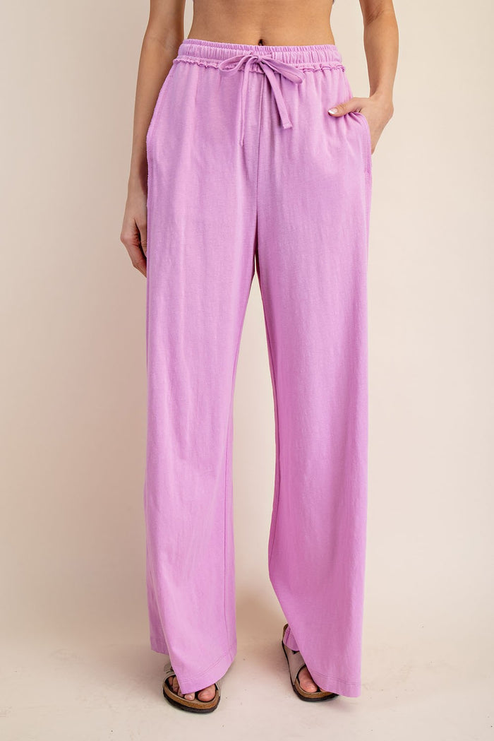 woman wearing light pink wide-leg pants with an adjustable drawstring waist and side pockets