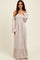 woman wearing a floral off-the-shoulder maxi dress with flared sleeves and a ruffled hem