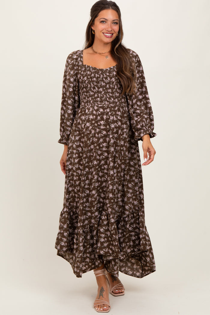 woman wearing a brown floral maternity maxi dress with a square neckline and puff sleeves