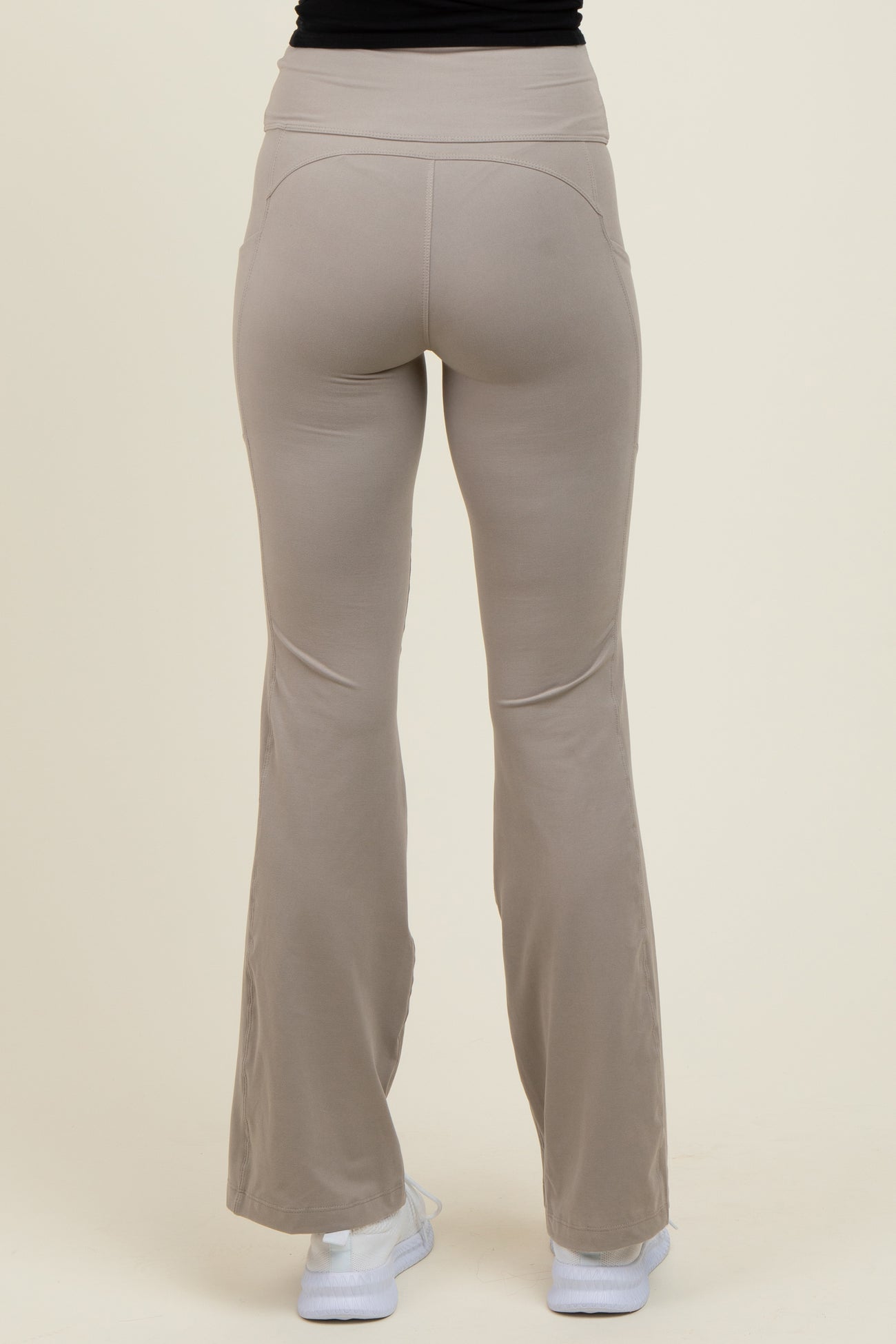 woman wearing light beige flared yoga pants, viewed from the back