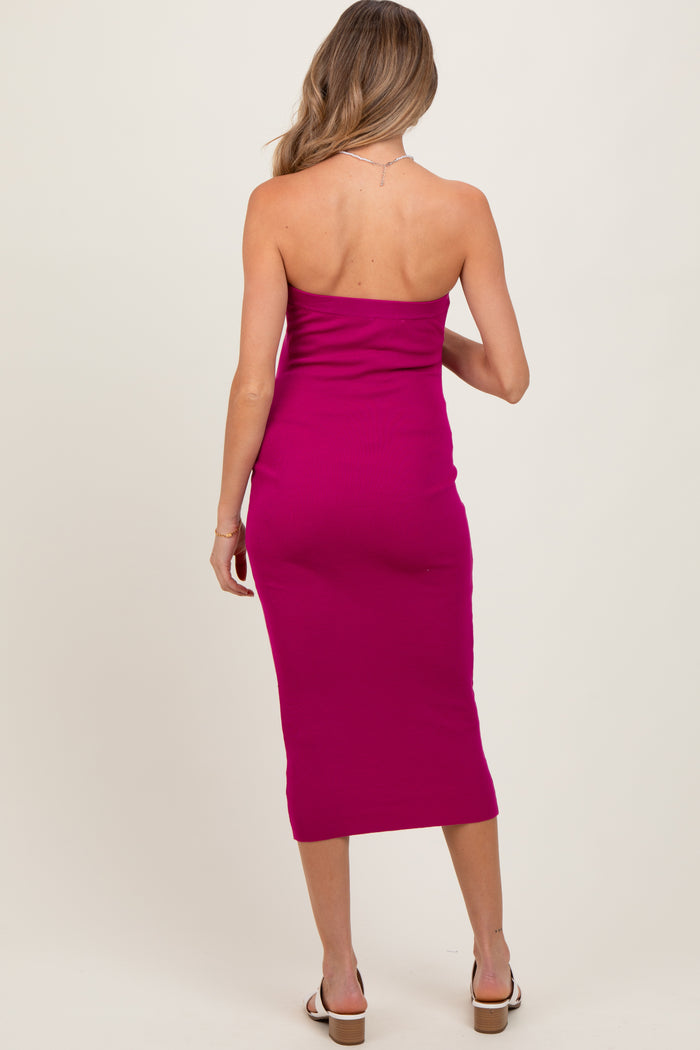 woman wearing a bright pink strapless maternity dress with a fitted silhouette and midi length from the back