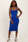 woman wearing a fitted royal blue ribbed midi dress with adjustable straps and button details